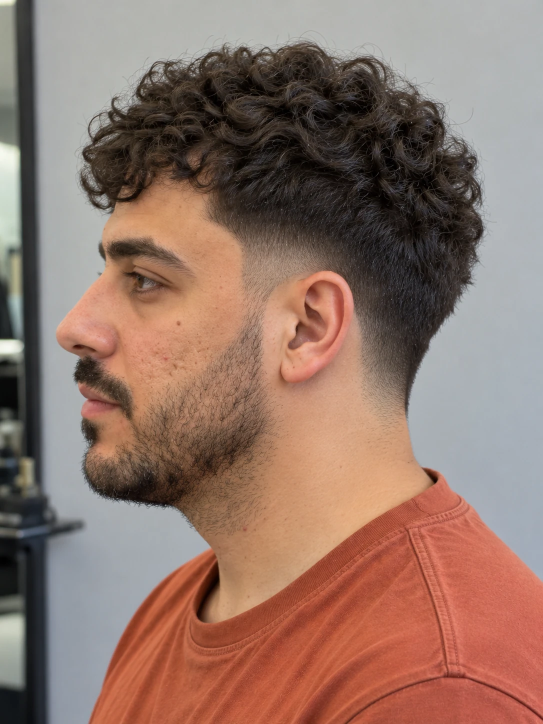 AI concept: compact curly crop with a low taper, left-side view.
