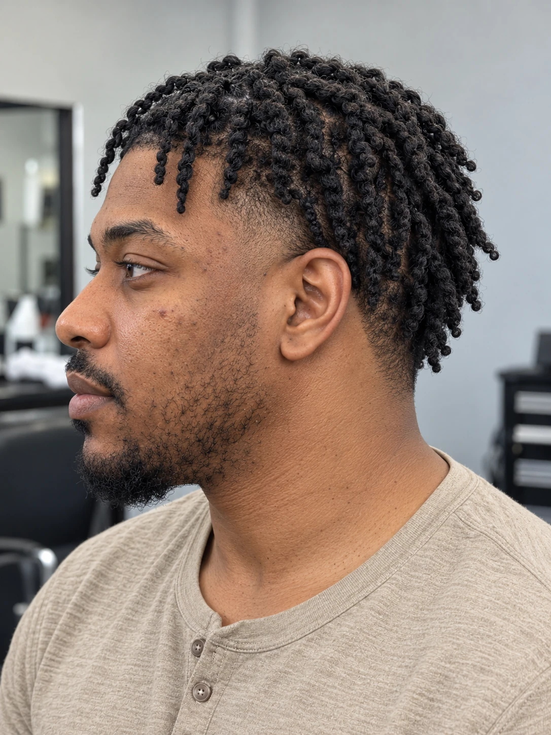 AI concept: defined coily twist top with a low taper, left-side view.