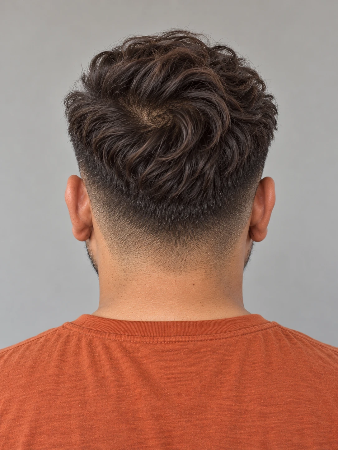 AI concept: loose wavy pompadour with a high taper, rear view.