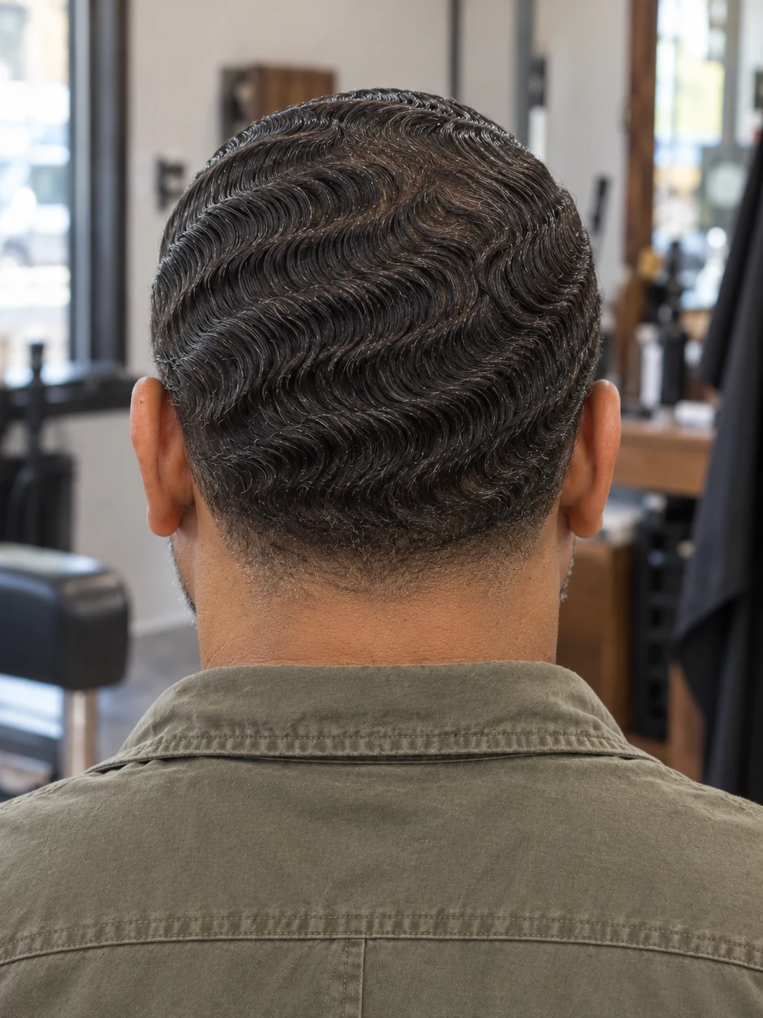 AI haircut concept: low taper with sculpted finger waves, rear view.