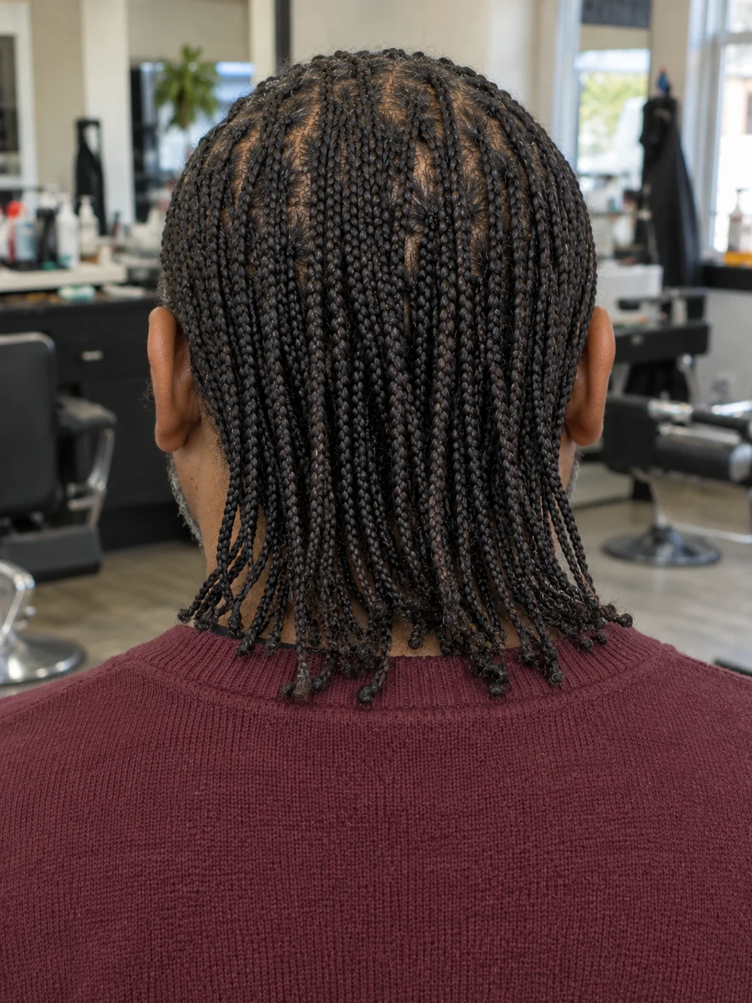 AI haircut concept: low taper with loose microbraids, rear view.