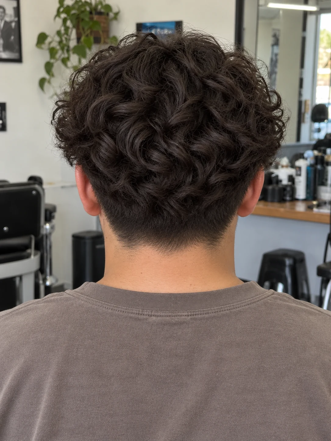 AI haircut concept: low taper with curly curtains, rear view.