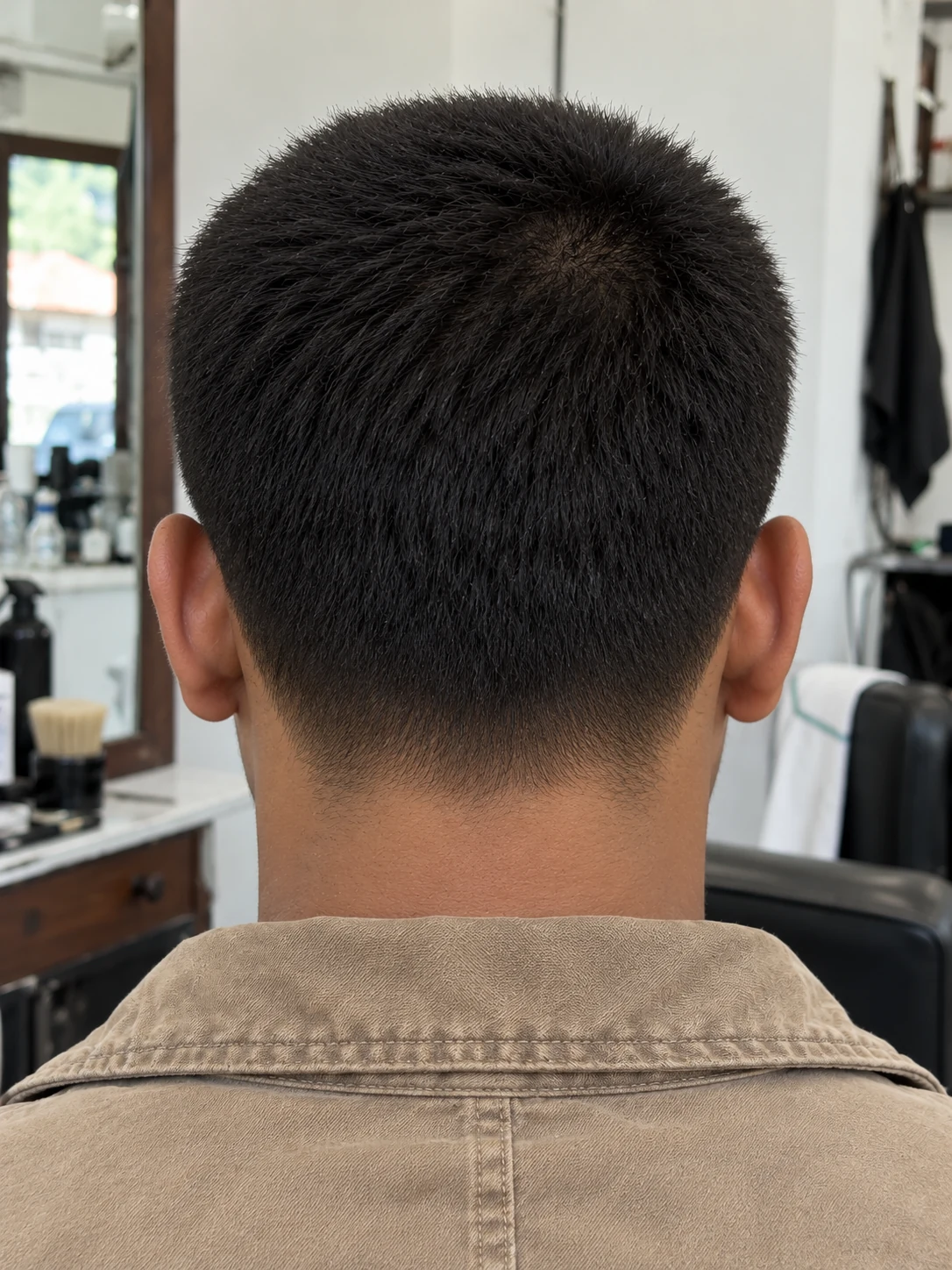 AI haircut concept: low taper with a compact butch cut, rear view.