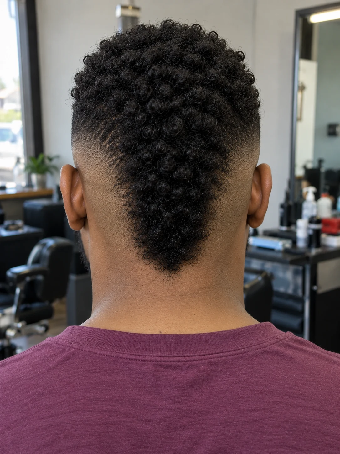 AI haircut concept: burst fade with a compact coily mohawk, rear view.