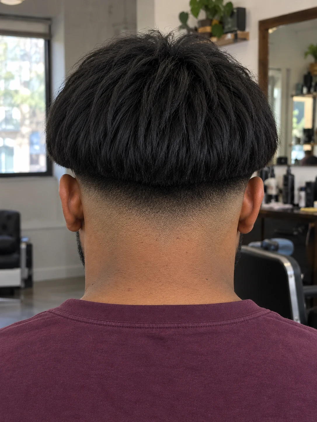 AI haircut concept: low drop fade with a heavy bowl fringe, rear view.